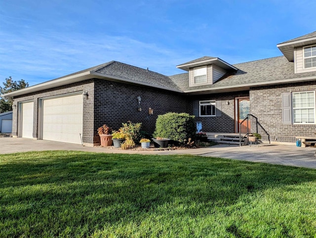 view of front of home featuring a garage and a front lawn