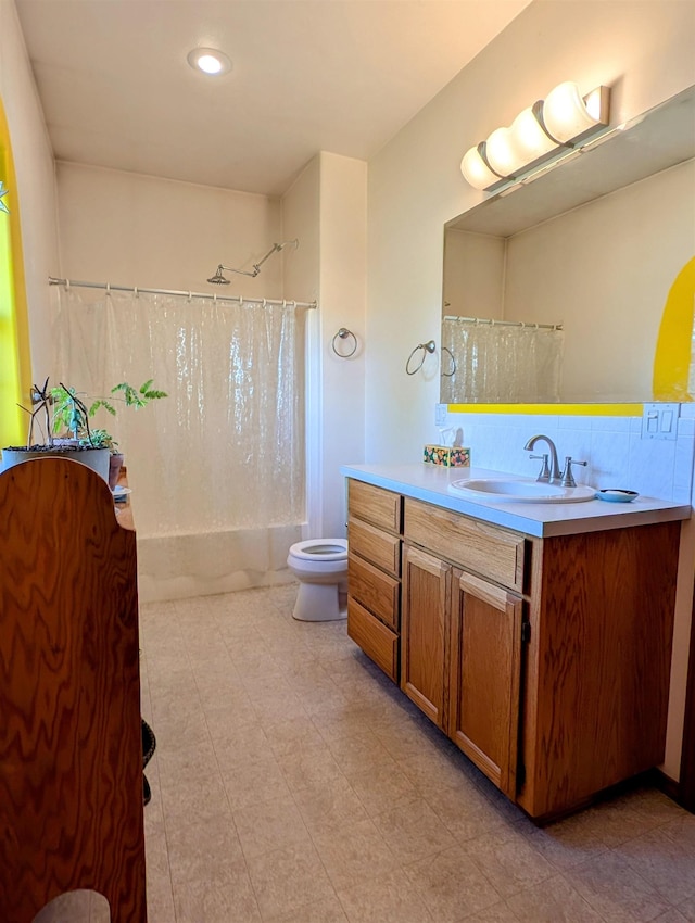 full bathroom featuring vanity, shower / bath combination with curtain, and toilet