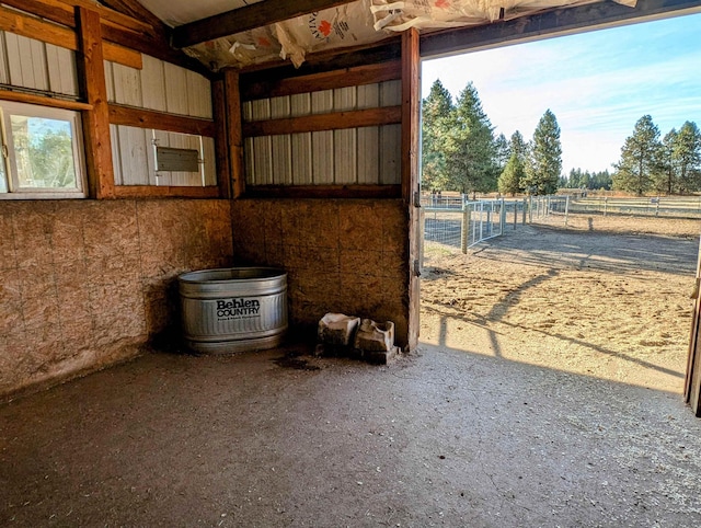 view of horse barn with a rural view