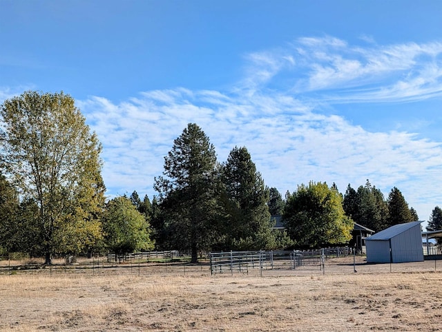 view of yard featuring an outbuilding and a rural view