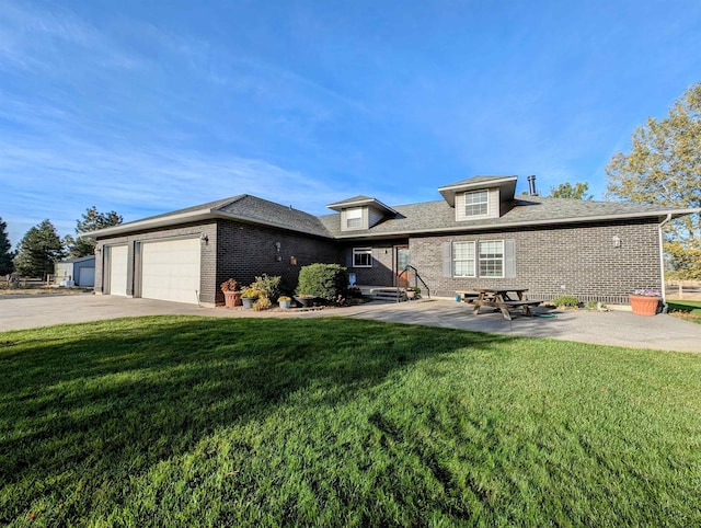 view of front facade featuring a garage, a patio area, and a front lawn