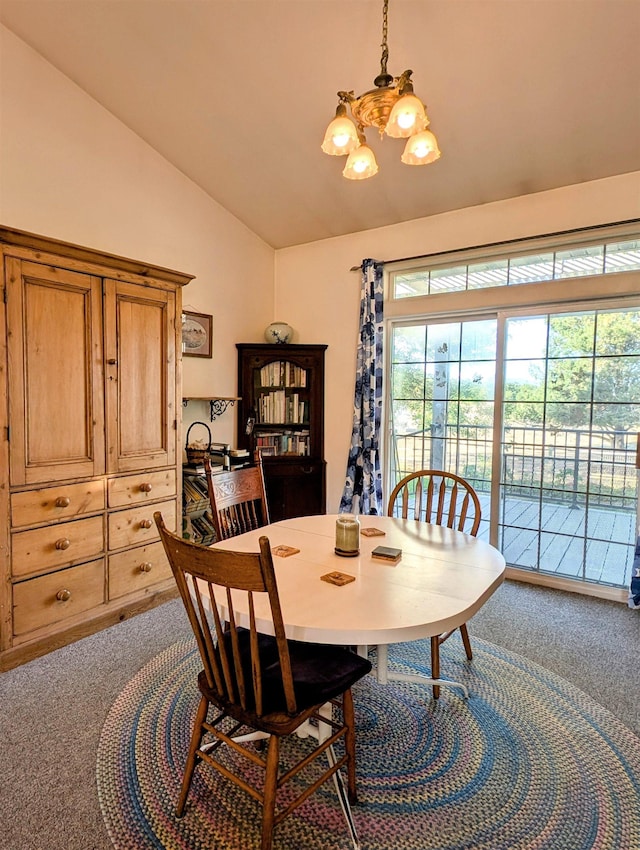 carpeted dining room featuring a notable chandelier and vaulted ceiling