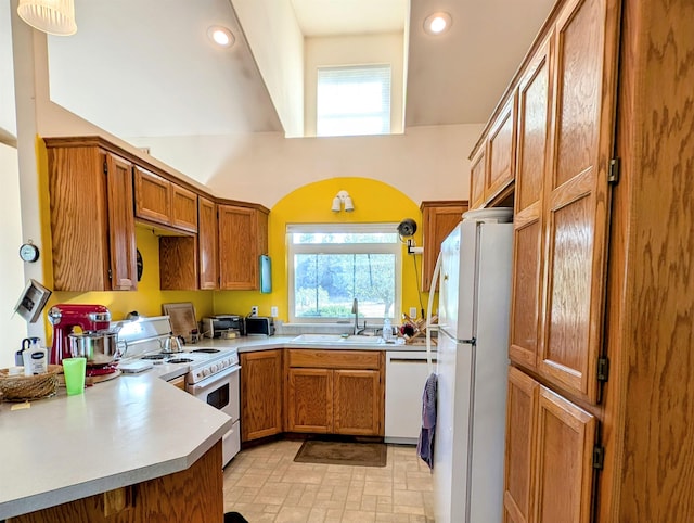 kitchen with sink, white appliances, and plenty of natural light