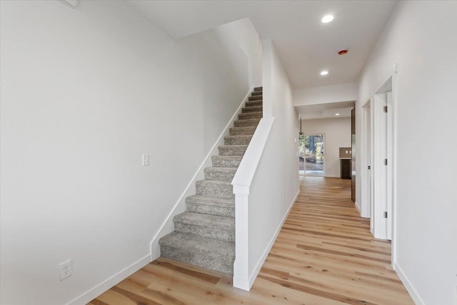 stairs featuring hardwood / wood-style floors