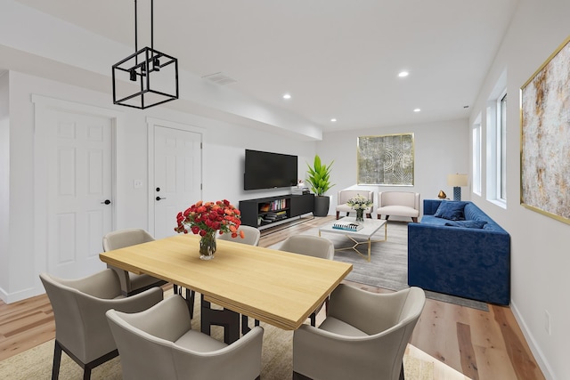 kitchen with tasteful backsplash, dark brown cabinets, stainless steel appliances, sink, and decorative light fixtures