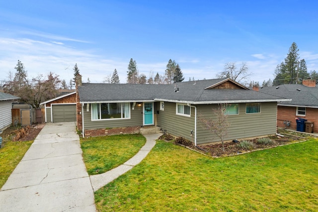 ranch-style home with a front yard, a garage, and an outbuilding