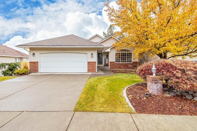 view of front of property with a garage and a front yard