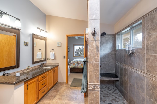 bathroom with vanity and tiled shower