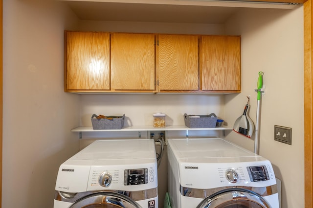 clothes washing area with cabinets and independent washer and dryer