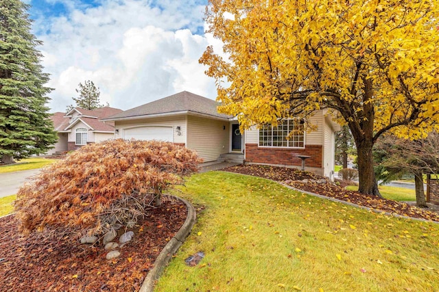 view of front of house featuring a garage and a front lawn