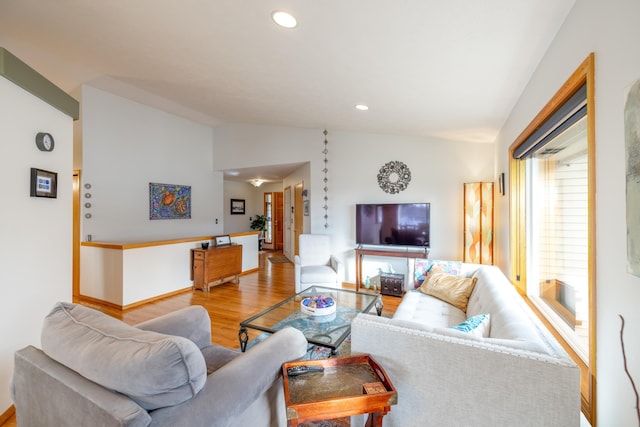 living room featuring hardwood / wood-style floors and vaulted ceiling