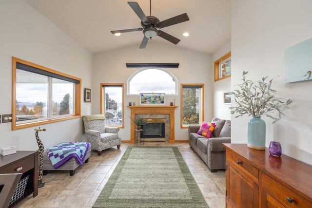 tiled living room with ceiling fan and vaulted ceiling