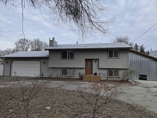 bi-level home with central AC and a garage