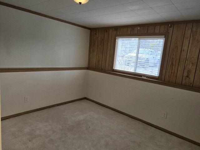 unfurnished room with light carpet and baseboards