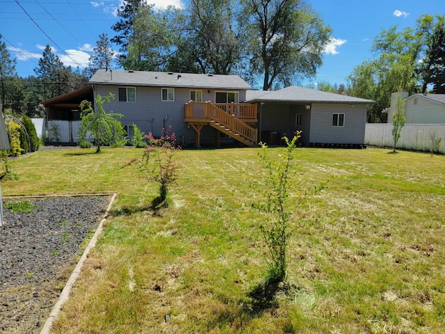 view of yard with stairs, a deck, and fence