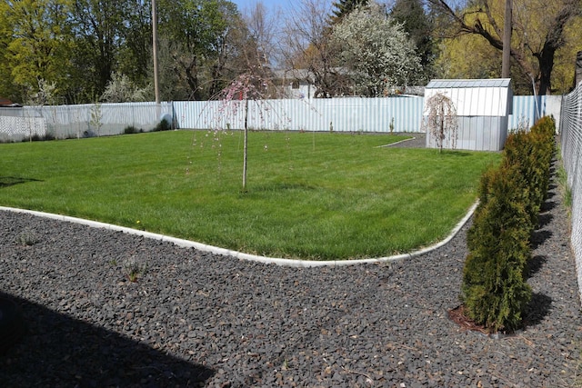 view of yard featuring an outbuilding and a fenced backyard