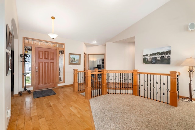 foyer with light hardwood / wood-style flooring and vaulted ceiling