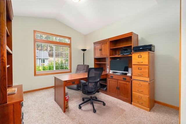 carpeted office featuring vaulted ceiling