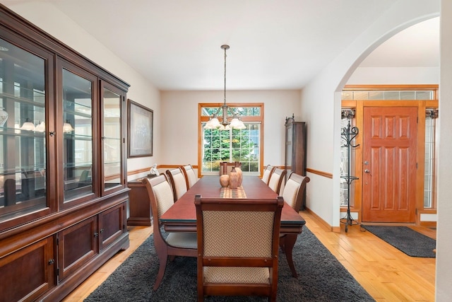 dining space featuring a chandelier and light wood-type flooring