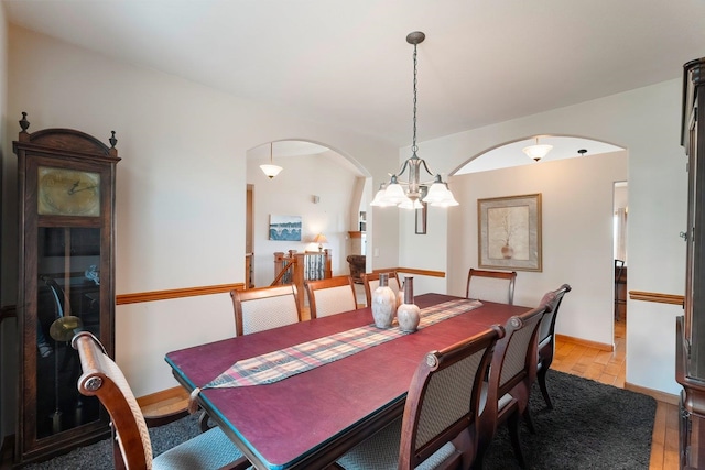 dining space featuring a notable chandelier and light wood-type flooring