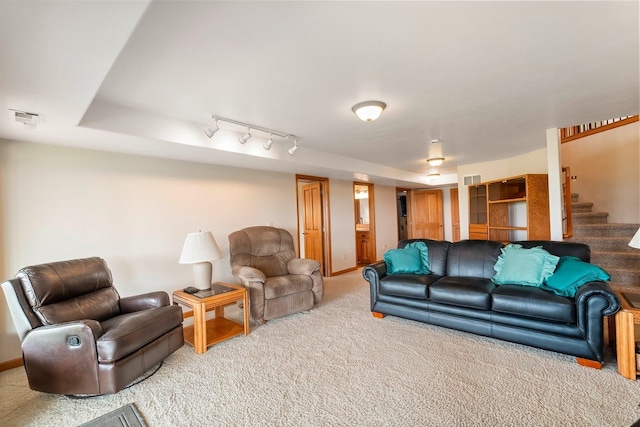 living room with carpet and track lighting