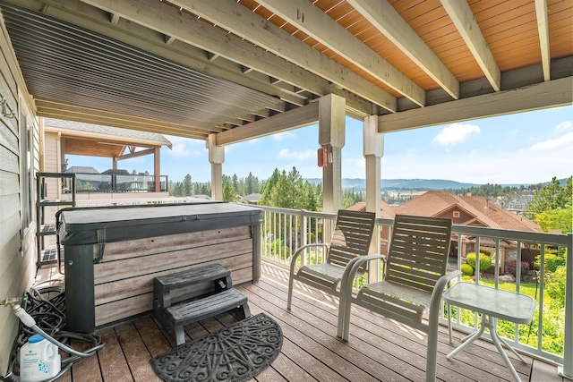 wooden deck featuring a hot tub