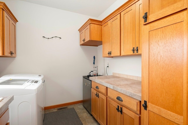 washroom with washer and clothes dryer and cabinets