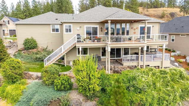 back of house featuring a wooden deck