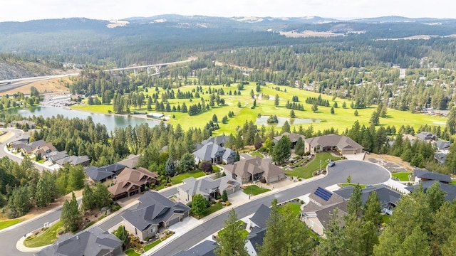 birds eye view of property with a water and mountain view