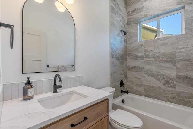 full bathroom with toilet, vanity, and washtub / shower combination