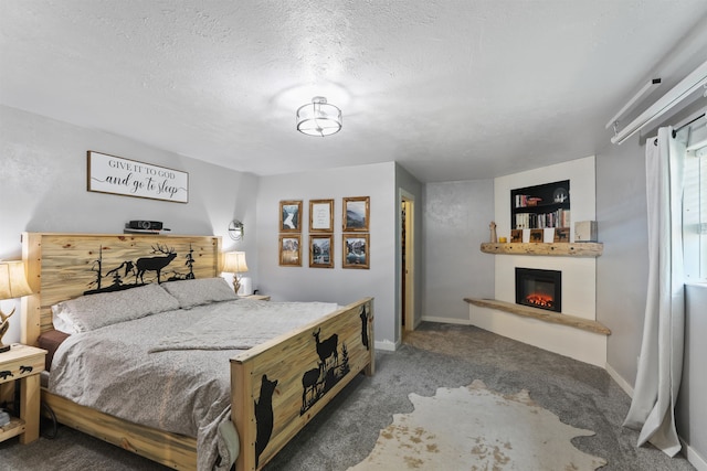 bedroom featuring carpet flooring and a textured ceiling