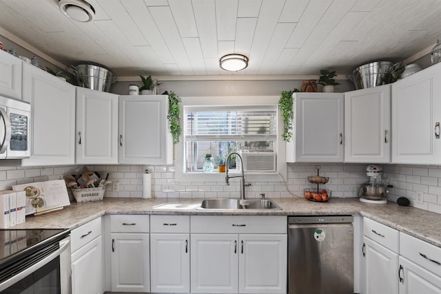 kitchen featuring backsplash, sink, white cabinetry, and stainless steel appliances