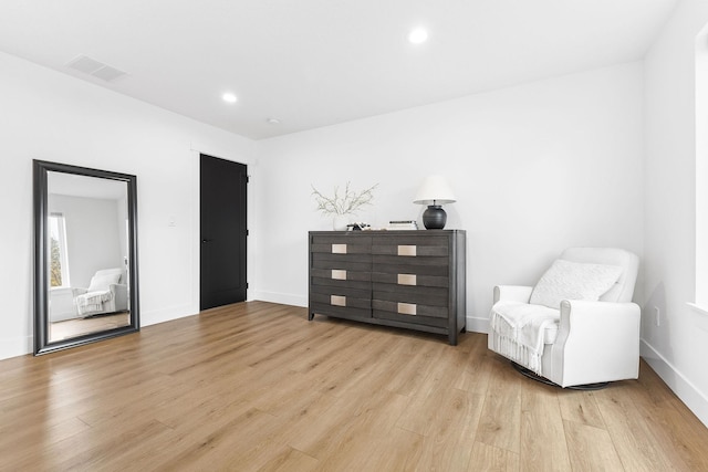 sitting room featuring light hardwood / wood-style flooring