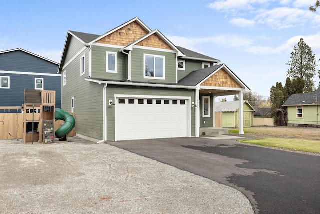 craftsman inspired home featuring a playground and a garage