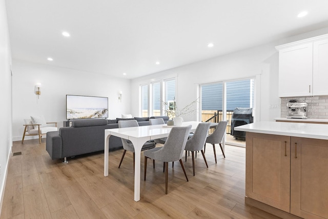 dining space with light hardwood / wood-style floors