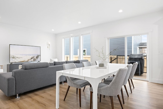 dining space with plenty of natural light and light hardwood / wood-style flooring