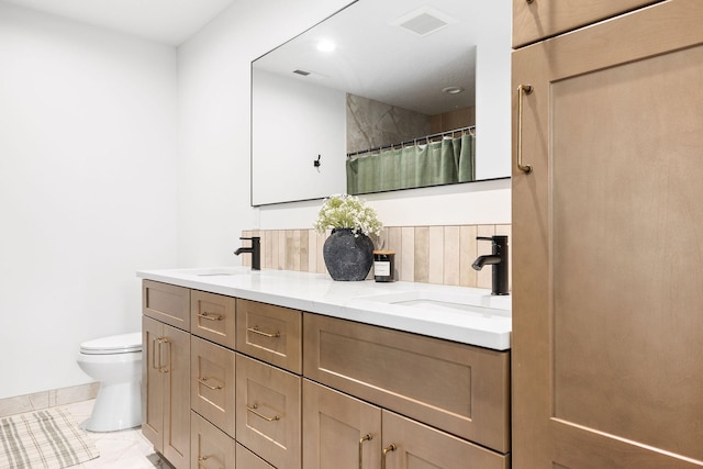 bathroom with tile patterned flooring, vanity, toilet, and a shower with shower curtain