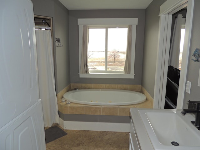 bathroom with tiled bath and sink