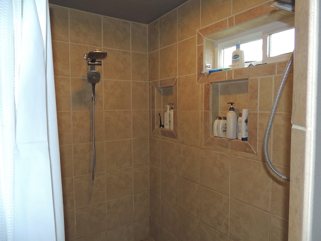 bathroom with a tile shower