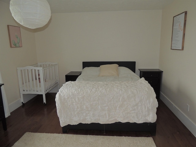 bedroom featuring dark hardwood / wood-style flooring