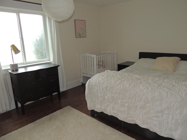 bedroom featuring dark wood-type flooring