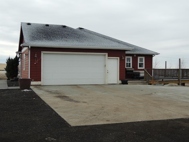 view of home's exterior featuring a garage and a wooden deck