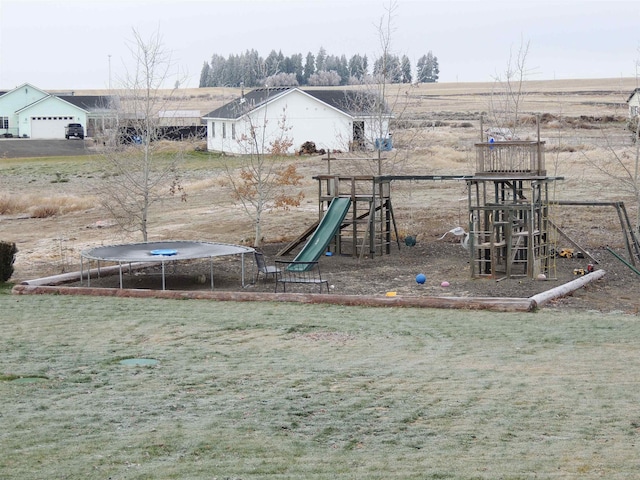 view of play area with a rural view, a trampoline, and a lawn