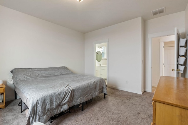 bedroom with carpet flooring and ensuite bath