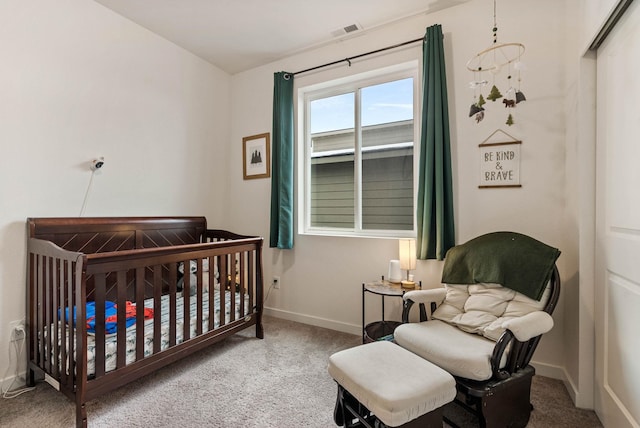 bedroom featuring a crib and carpet floors