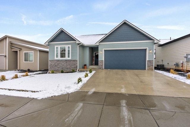 view of front of house with central air condition unit and a garage