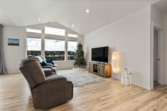 living room featuring light hardwood / wood-style floors and vaulted ceiling