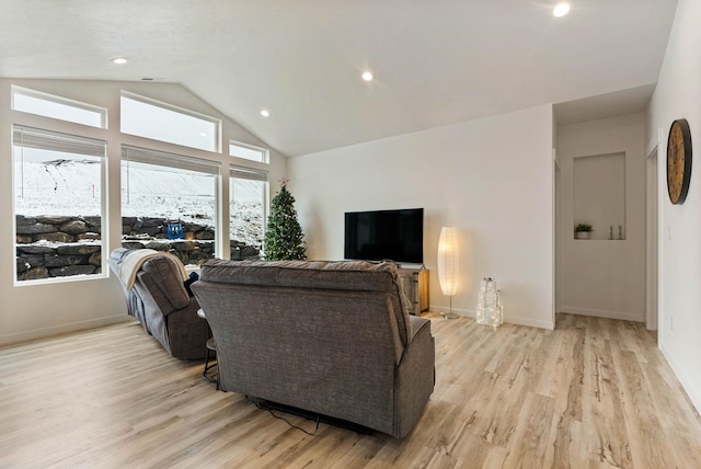 living room featuring light hardwood / wood-style floors and vaulted ceiling