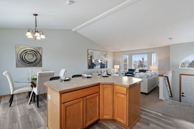 kitchen with light wood-type flooring, an inviting chandelier, and a kitchen island