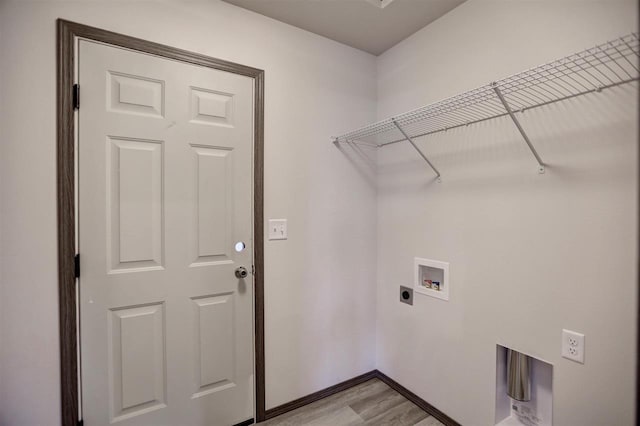 laundry area featuring hookup for an electric dryer, light hardwood / wood-style floors, and hookup for a washing machine